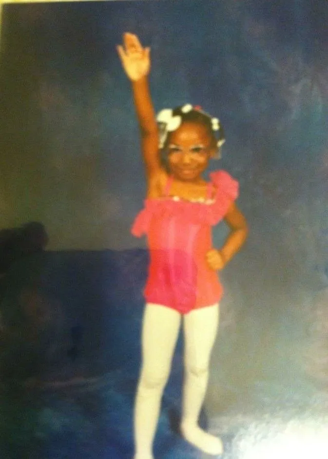 Nicole King as a child performing on stage.